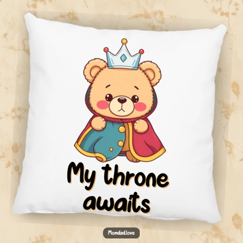 Funny pillow depicting a bewildered teddy bear wearing a miniature crown and a regal robe, offering cozy, humorous decor.